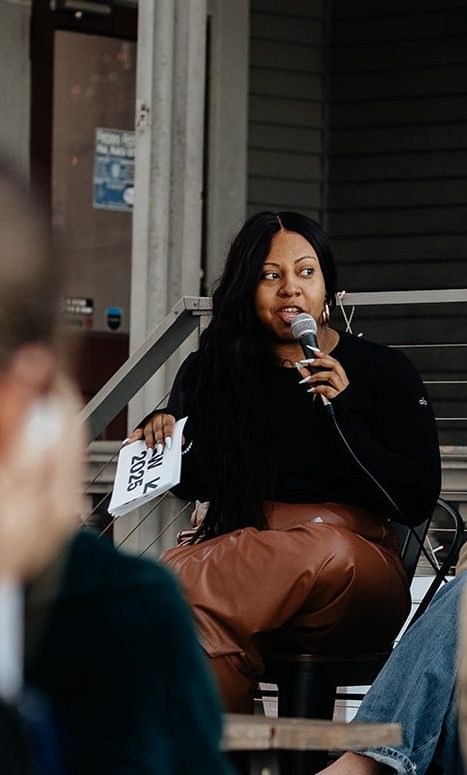 Ashley speaking mid-conversation at an event